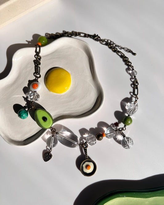 Necklace with colorful beads on a white dish