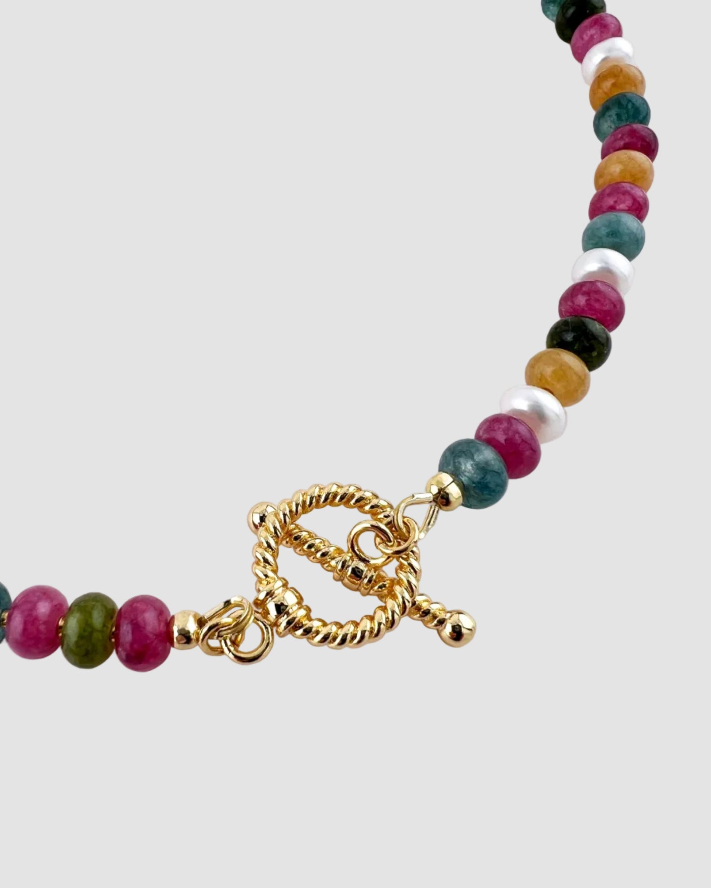 Multicolored beaded necklace with a gold clasp on a white background