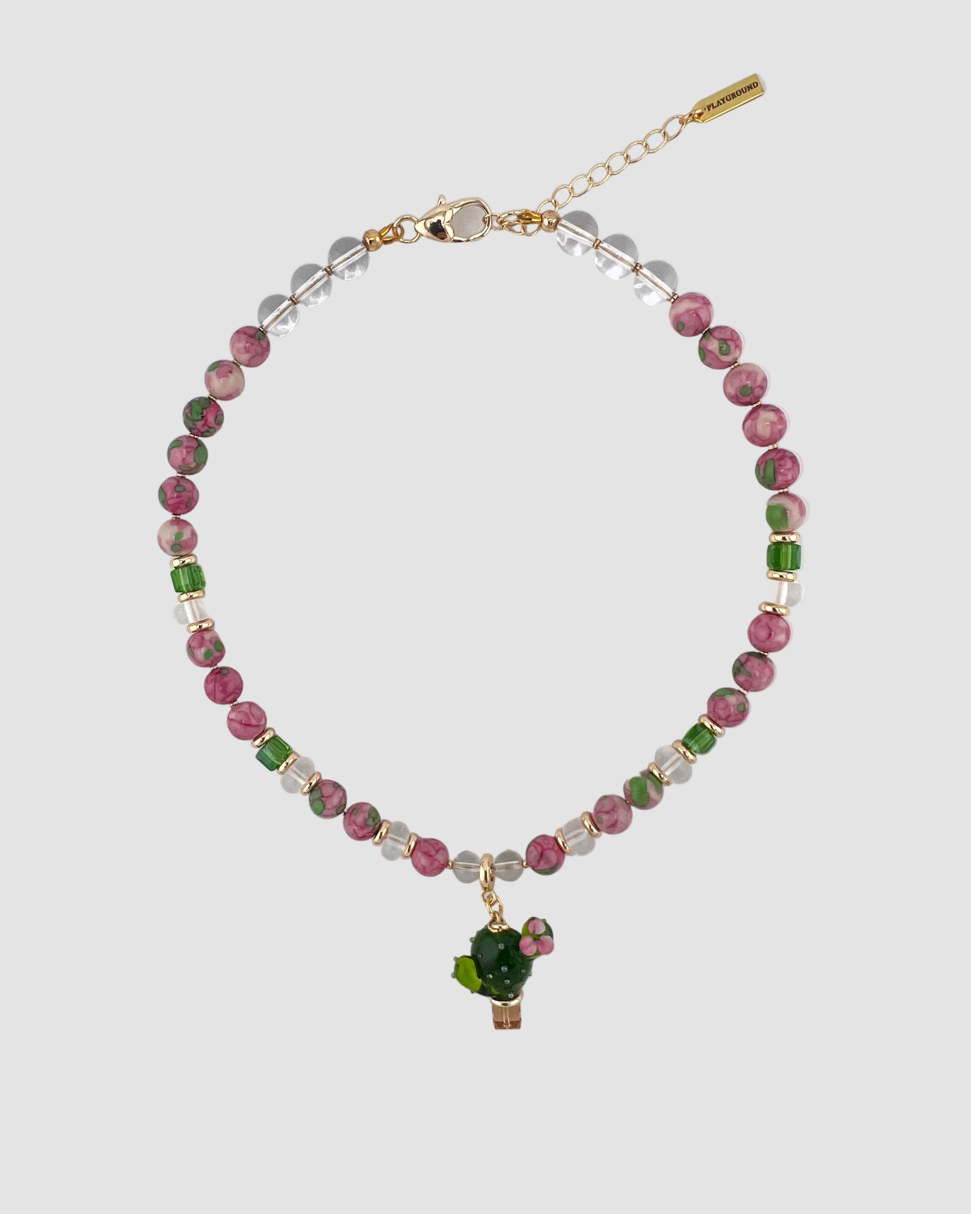 Necklace with multicolored beads and a small pendant on a light gray background