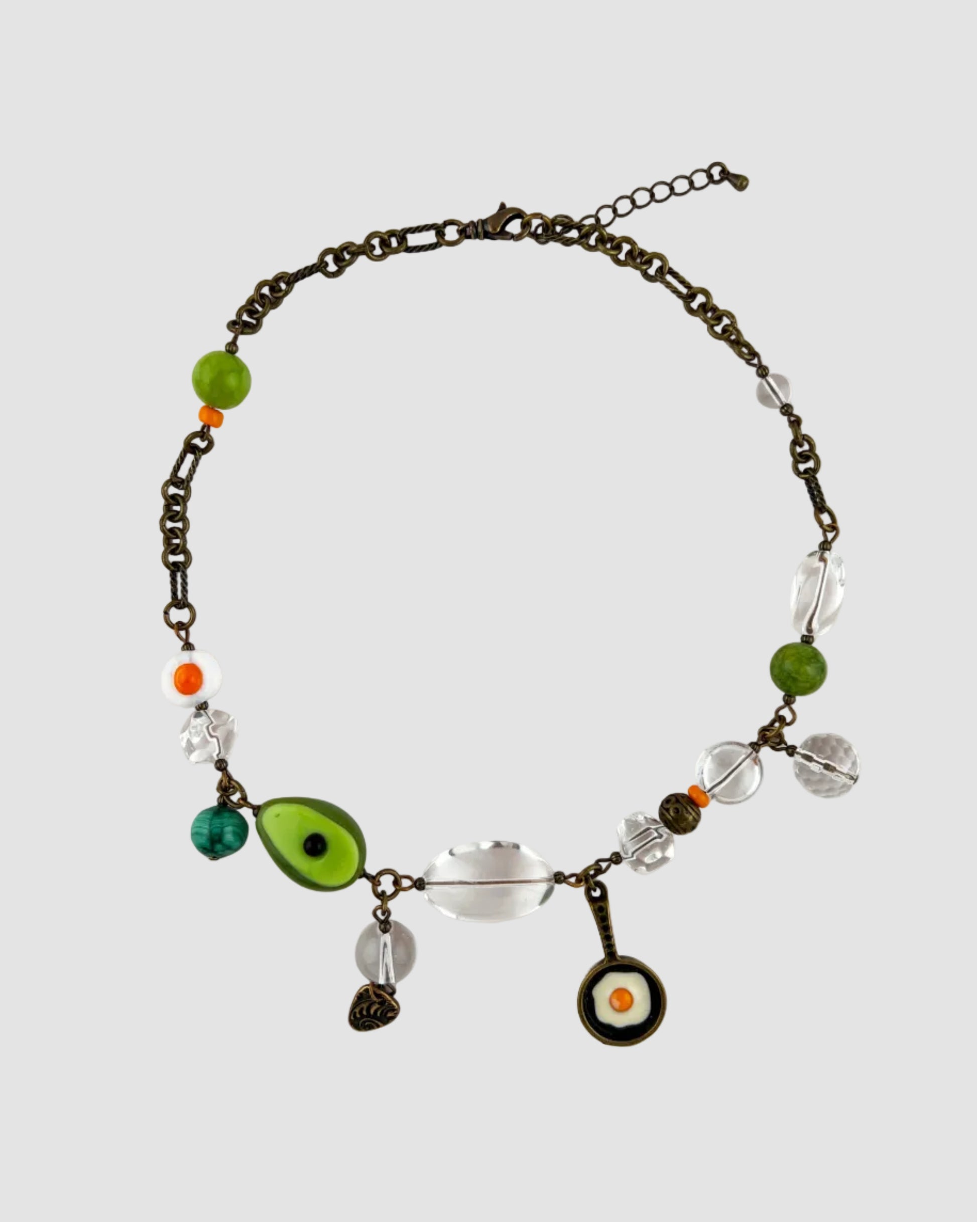 Necklace with various beads and charms on a white background