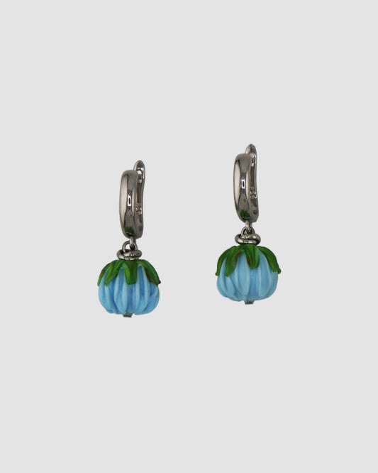 Pair of earrings with blue flowers beads on a light gray background