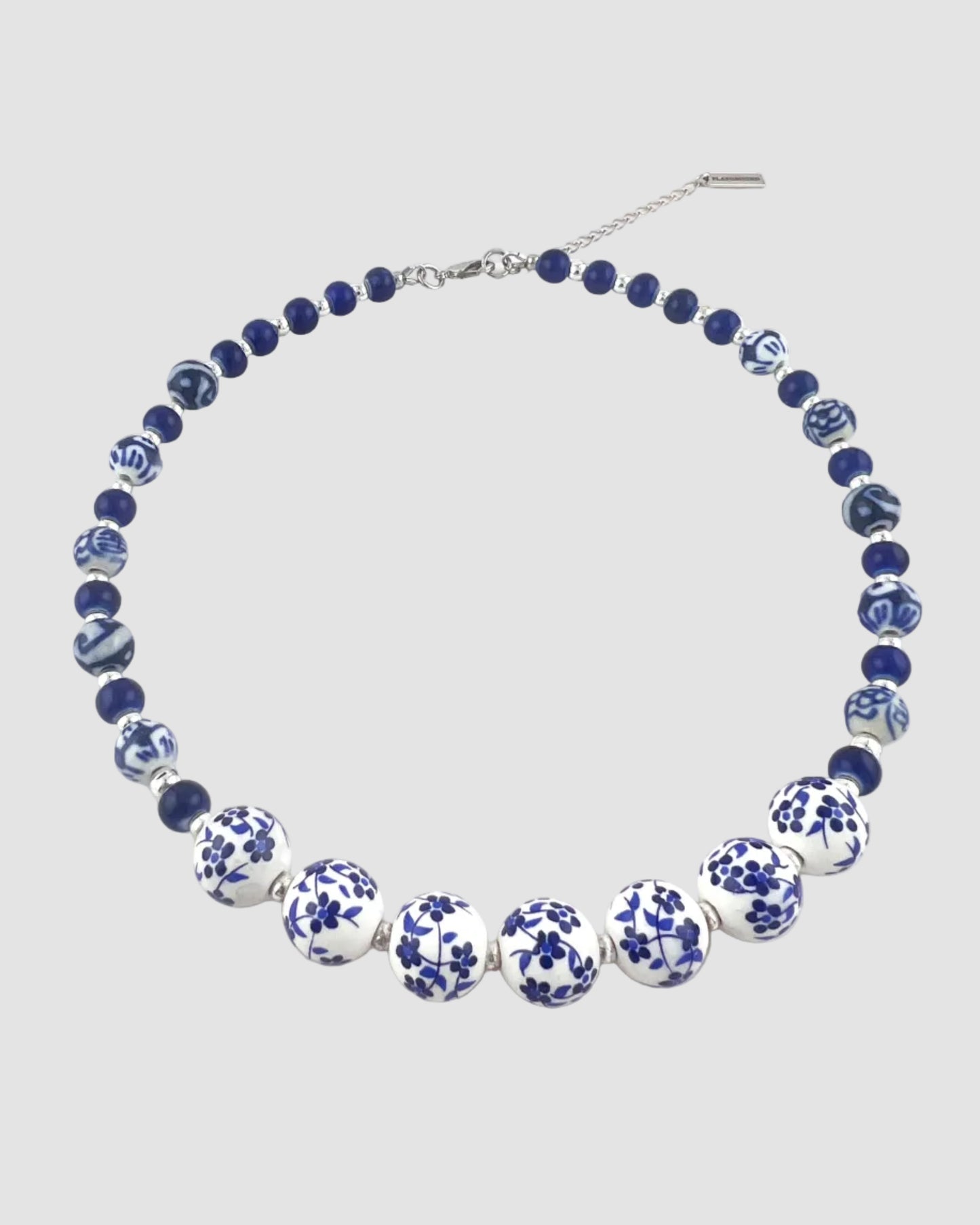 Necklace with blue and white floral beads on a white background