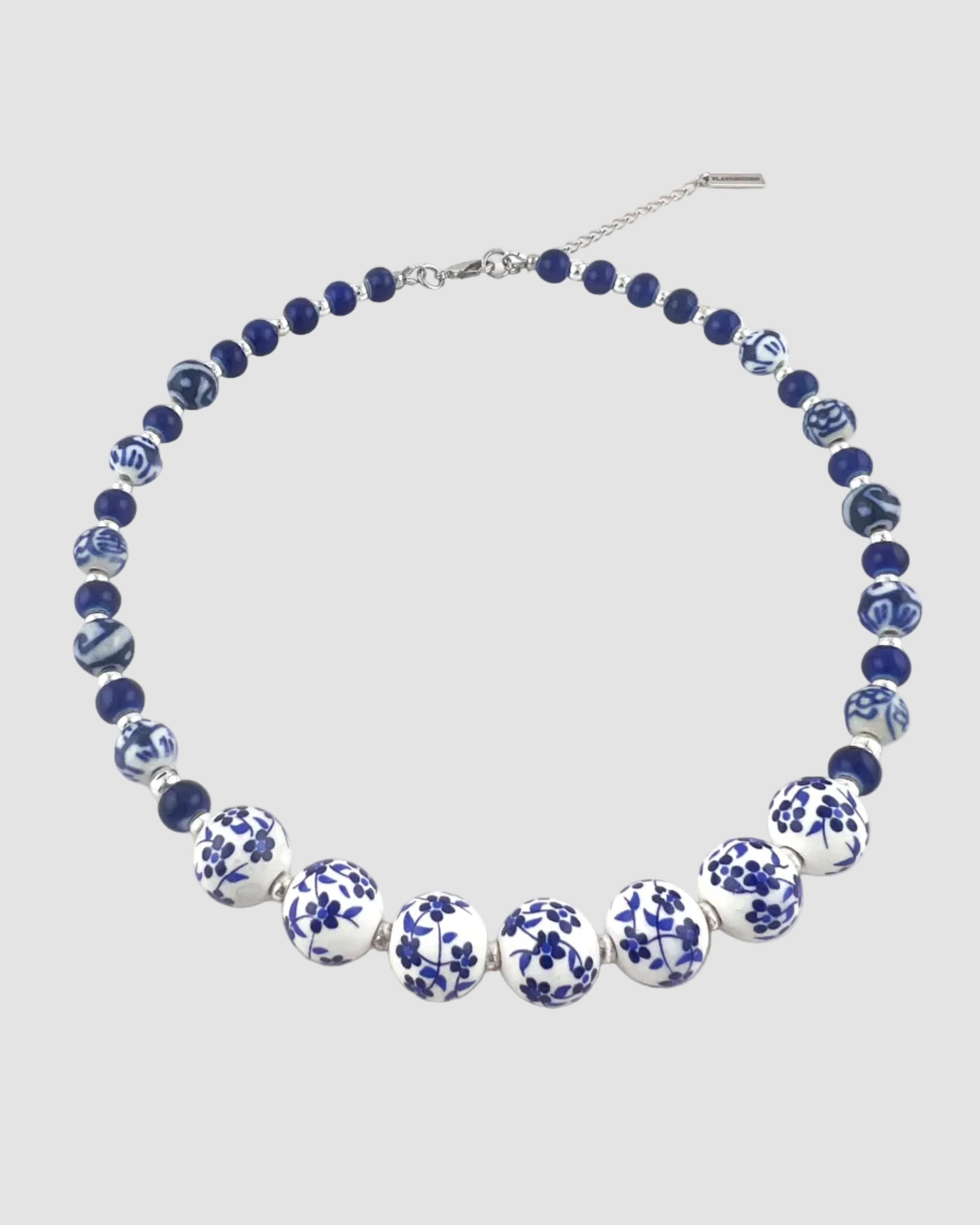 Necklace with blue and white floral beads on a white background