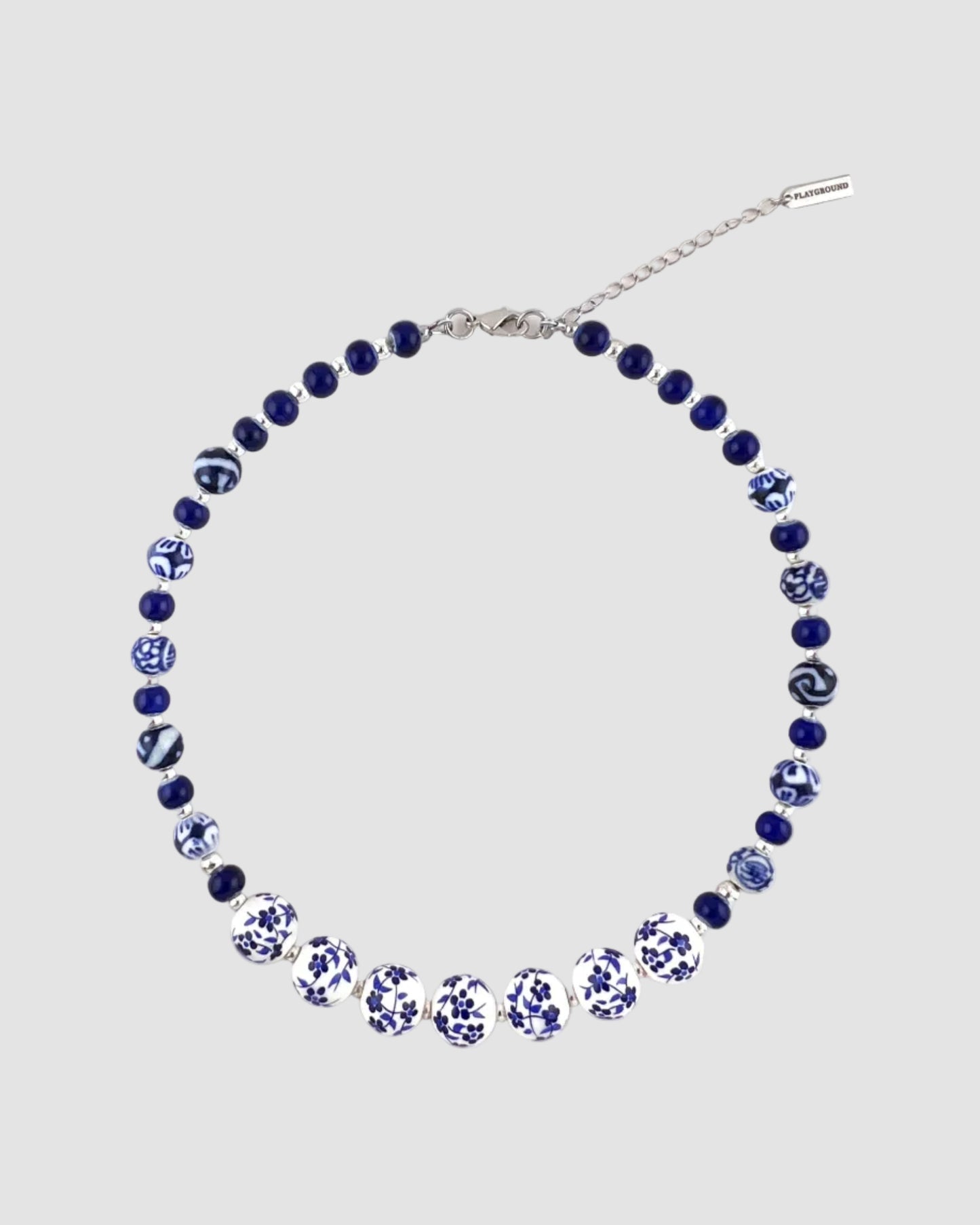 Necklace with blue and white beads on a white background