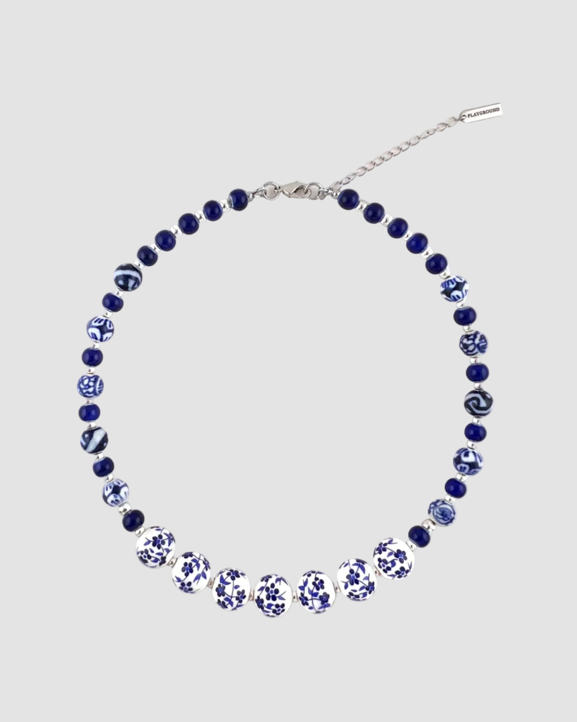 Necklace with blue and white beads on a white background