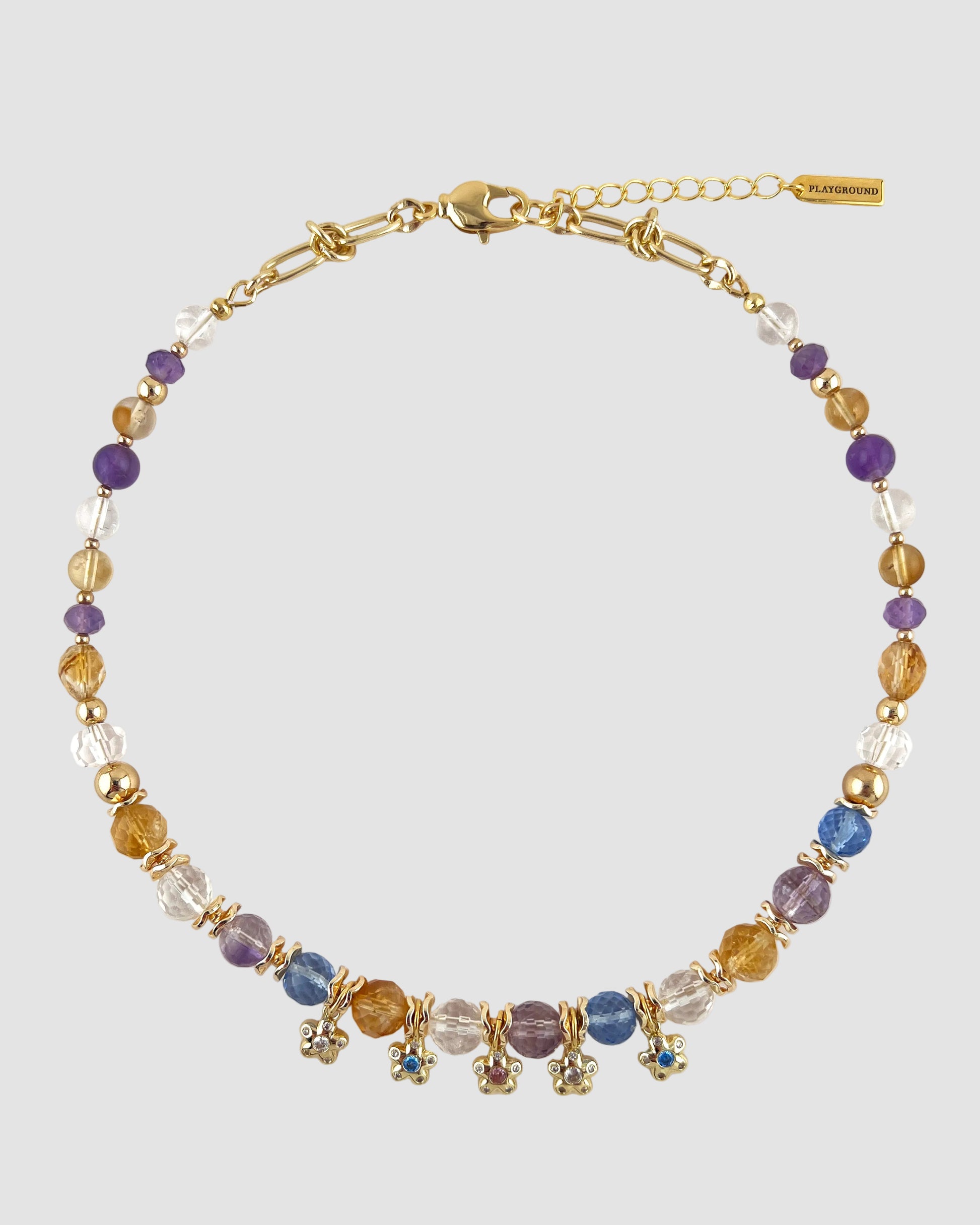 Multicolored beaded necklace with gold chain on a white background