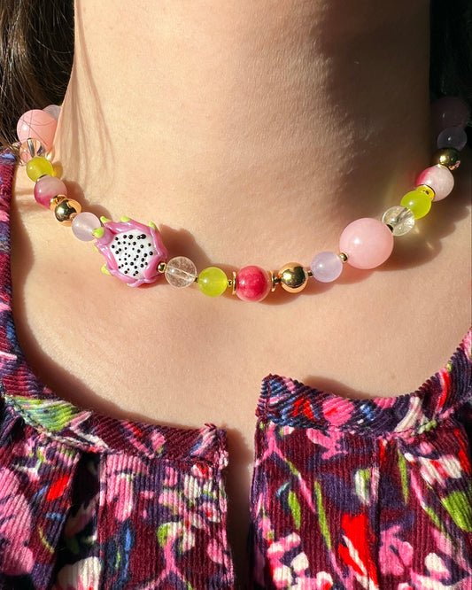 Colorful beaded necklace worn by a person with a floral top