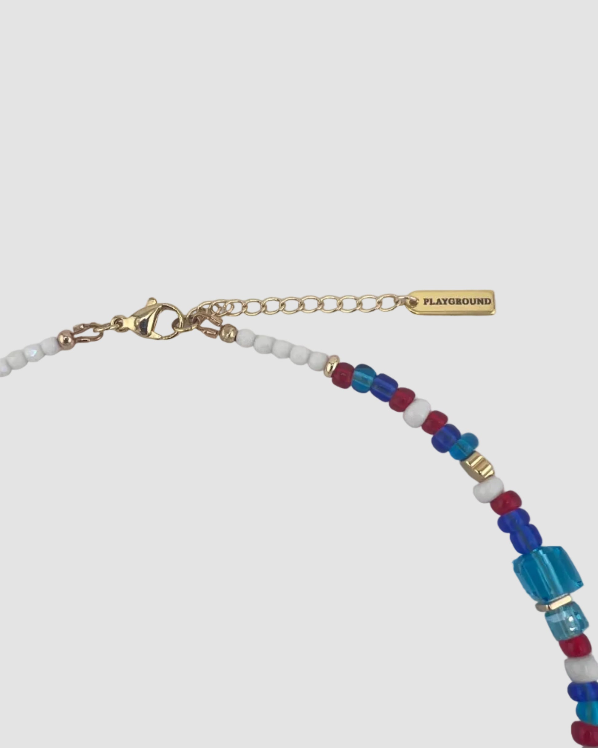 Necklace with colorful beads and gold clasp on a light gray background