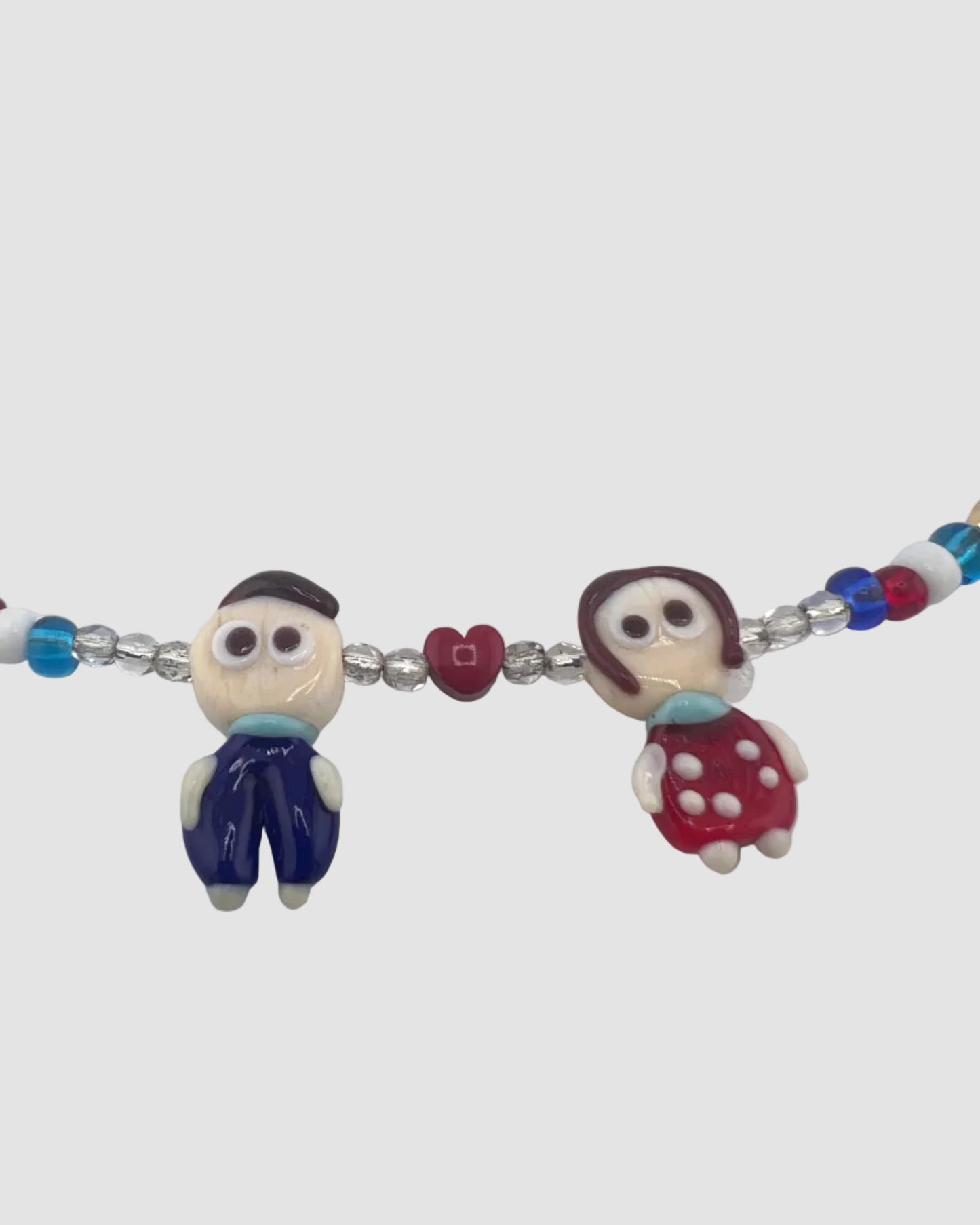 Necklace with colorful beads and cartoon character pendants on a white background