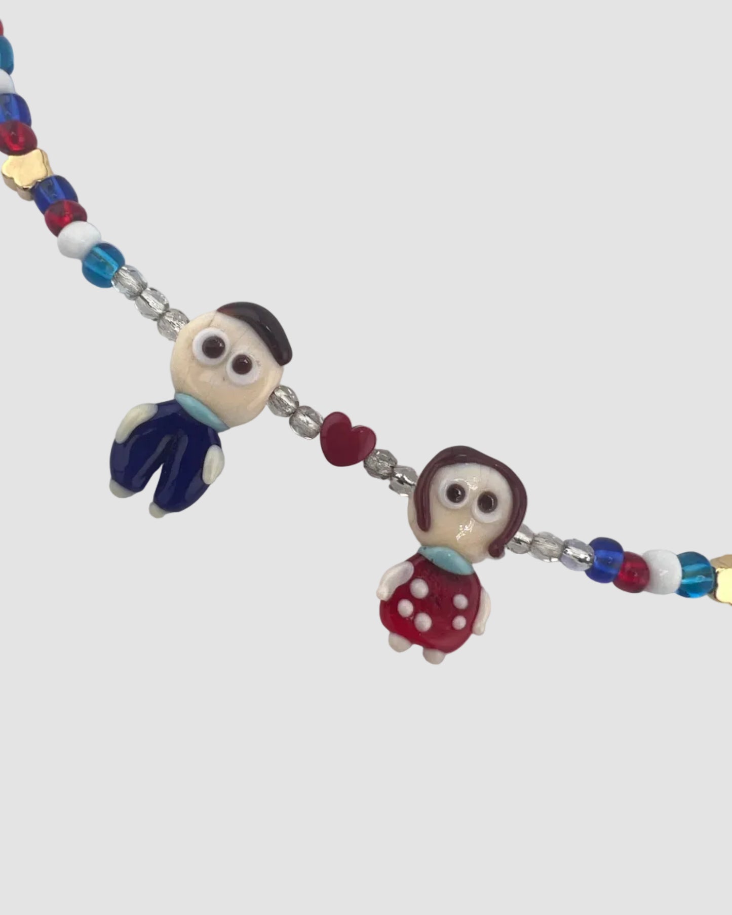 Colorful beaded necklace with cartoon character beads on a light gray background