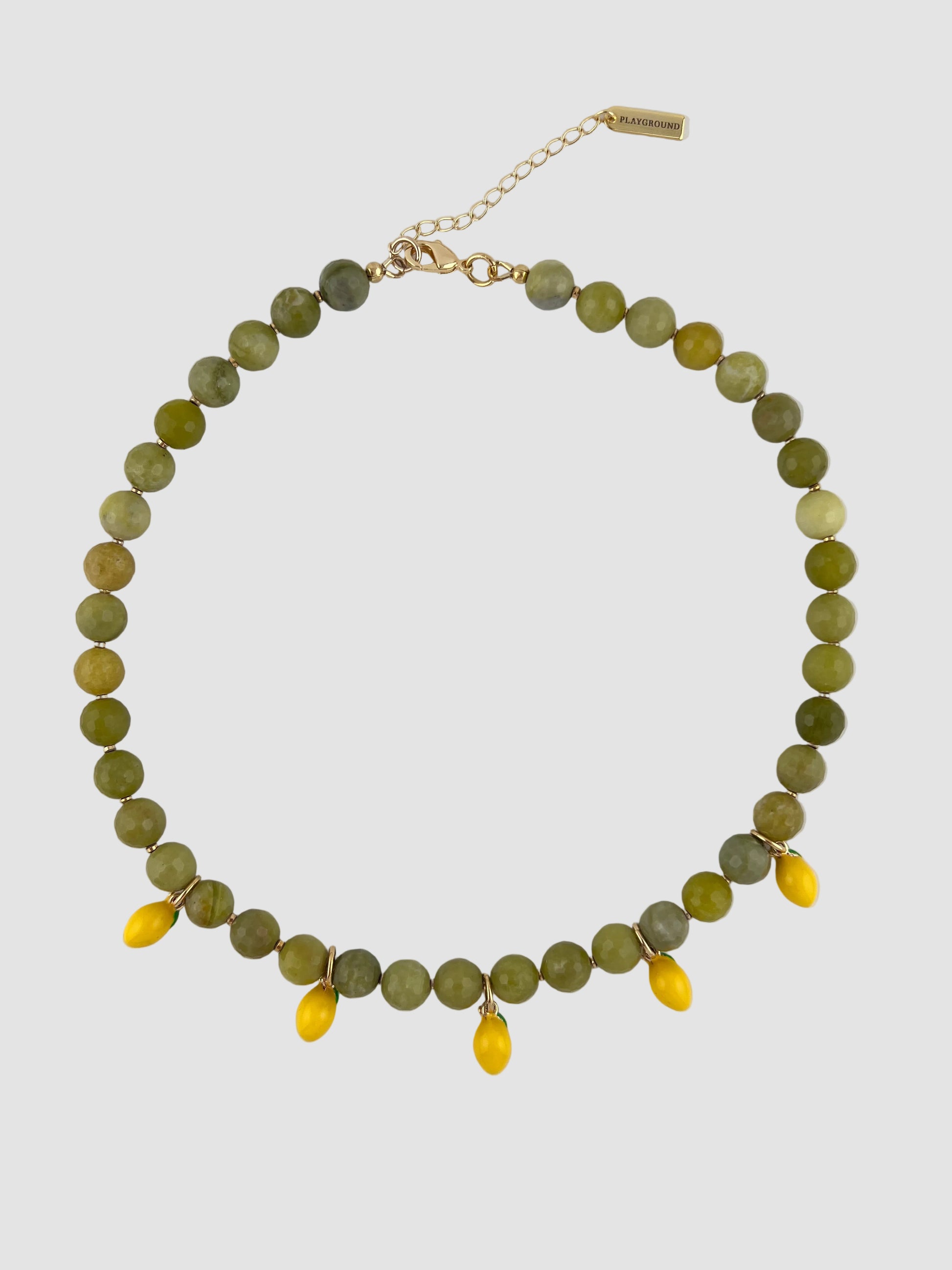 Necklace with green and yellow beaded chain on a white background