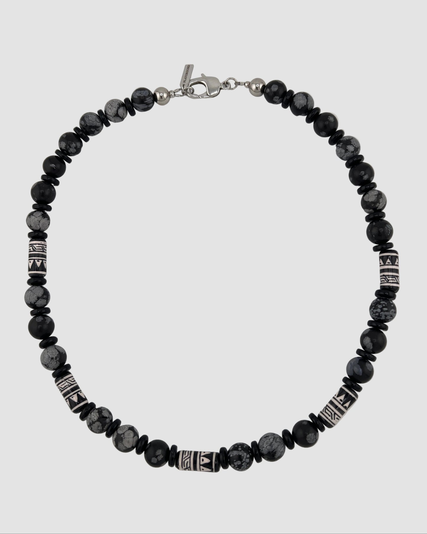 Black beaded bracelet with silver accents on a white background