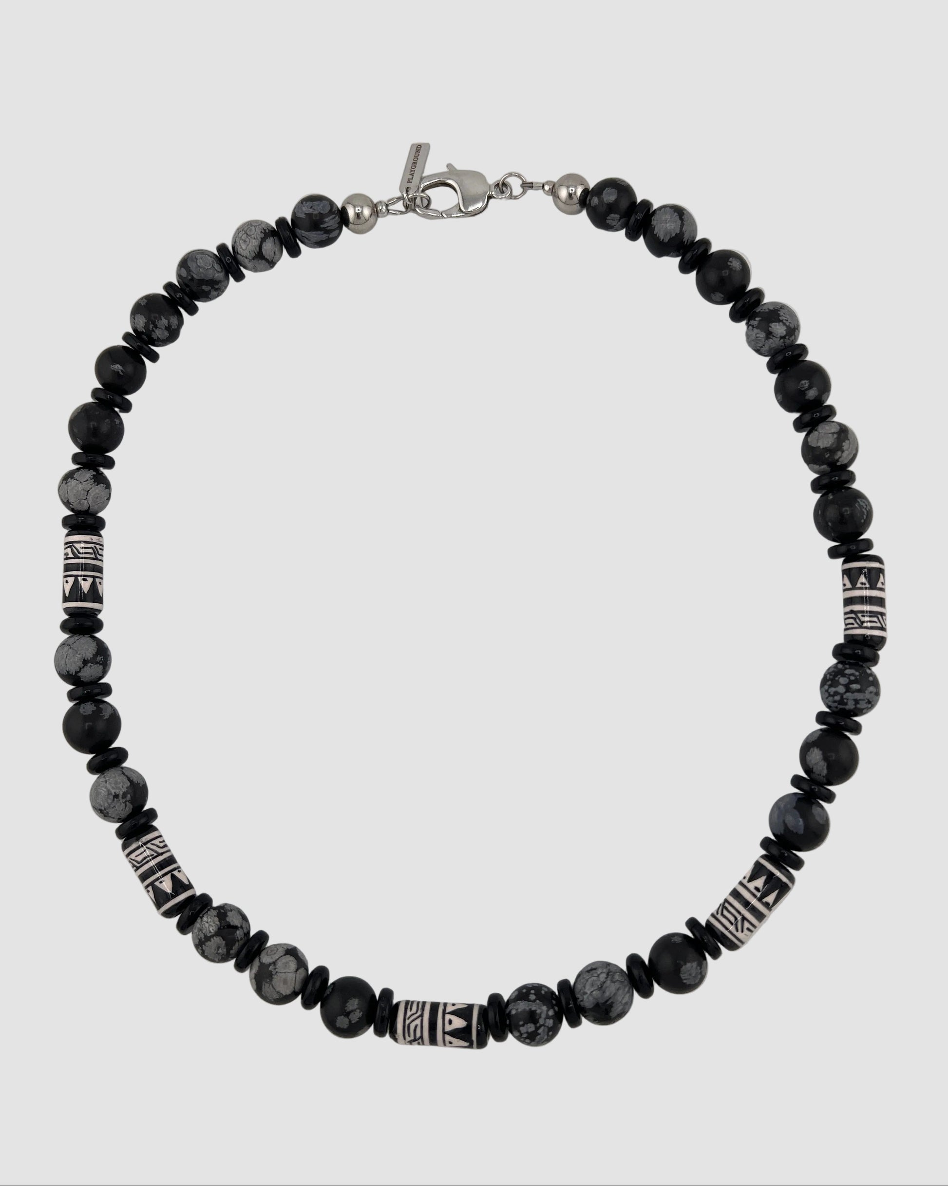 Black beaded bracelet with silver accents on a white background