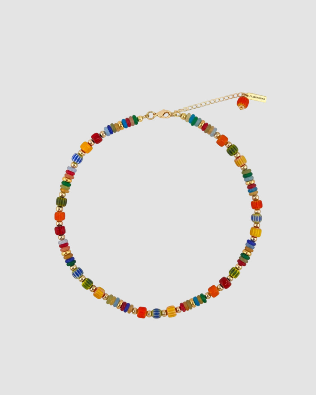 A colorful beaded necklace with small round beads in multiple bright colors, connected by a gold-tone chain with a lobster clasp and extender, photographed on a plain light background.