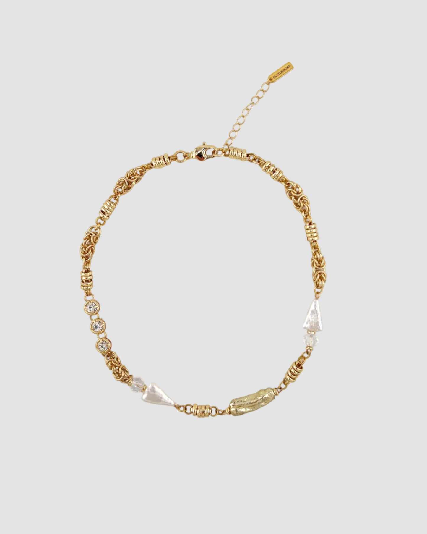Gold necklace with pearls on a white background