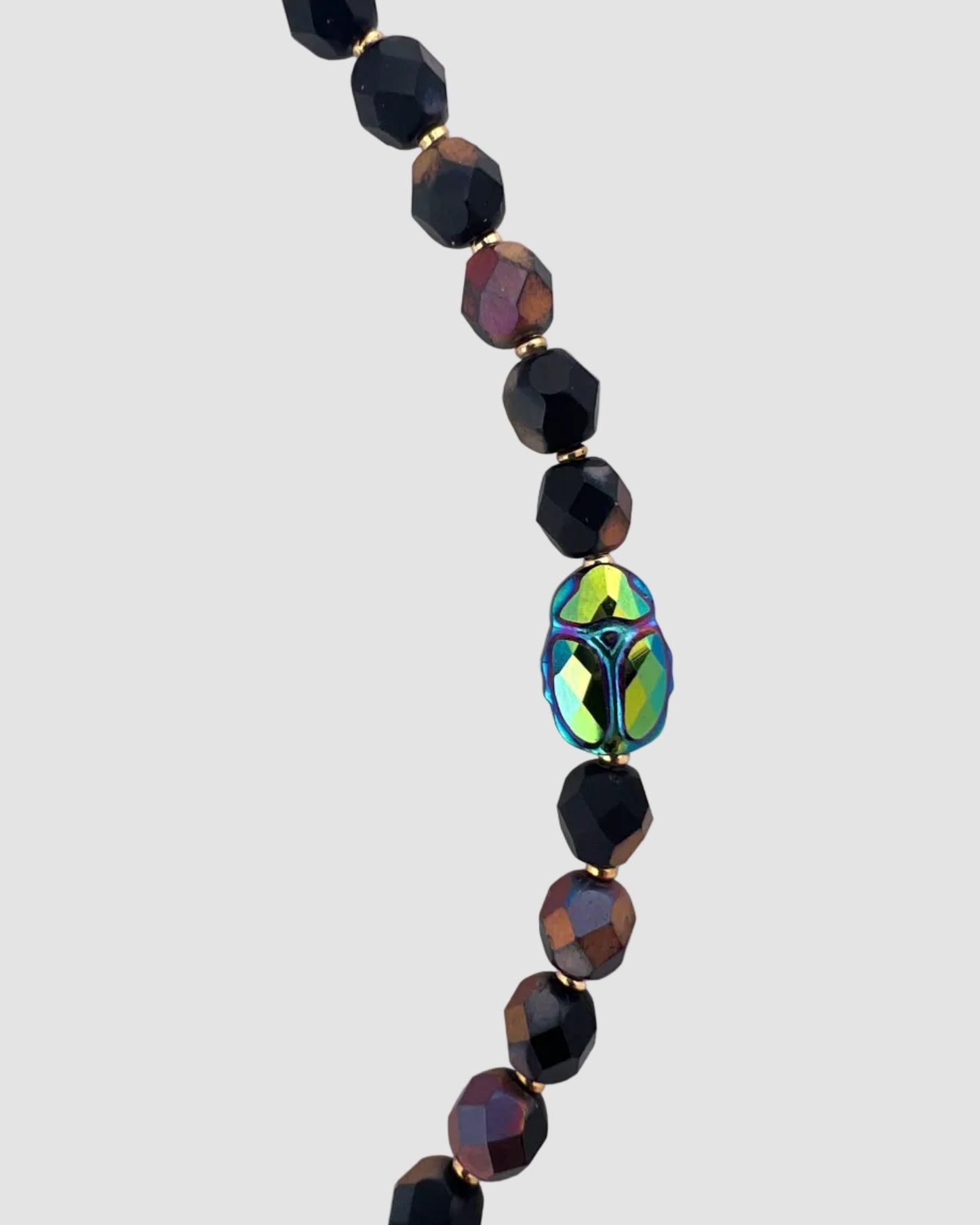 Necklace with black and multicolored beads on a white background